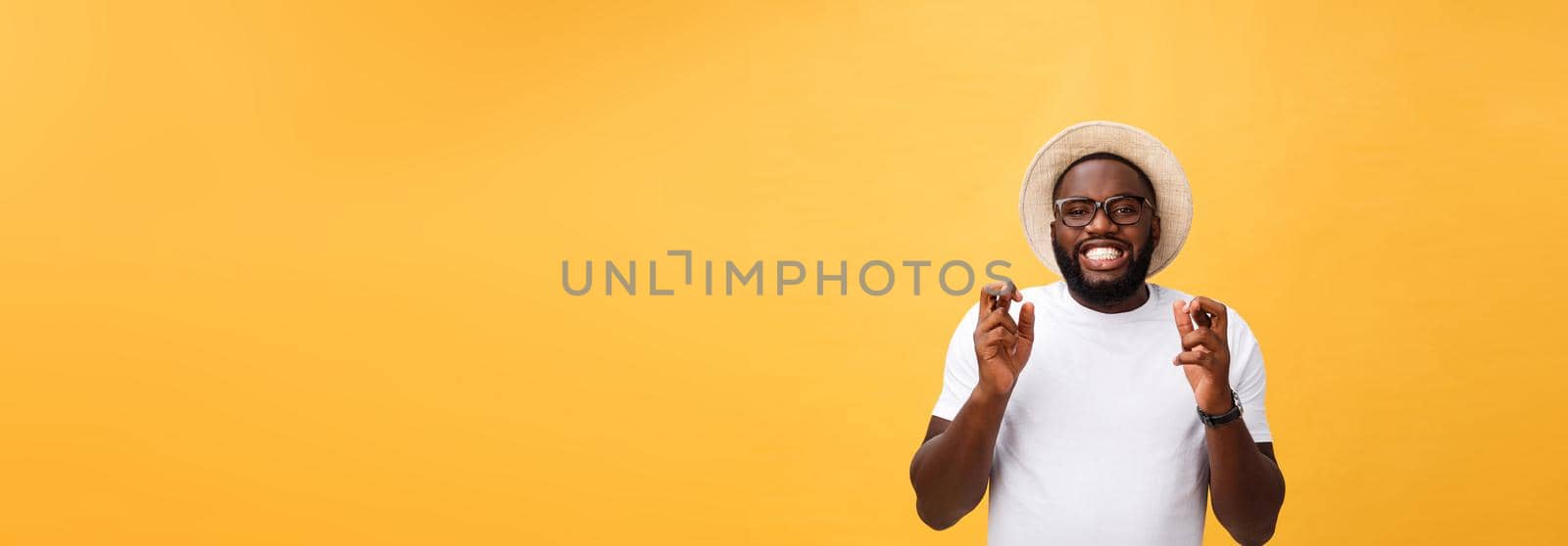 Young african american man over isolated background smiling crossing fingers with hope and eyes closed. Luck and superstitious concept by Benzoix