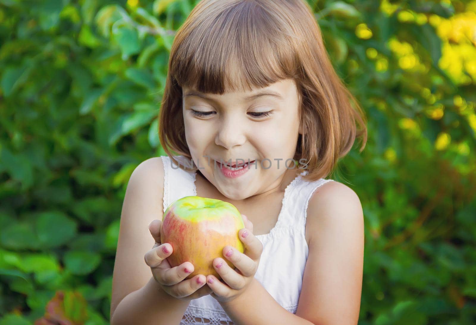 Child with an apple. Selective focus. nature food.