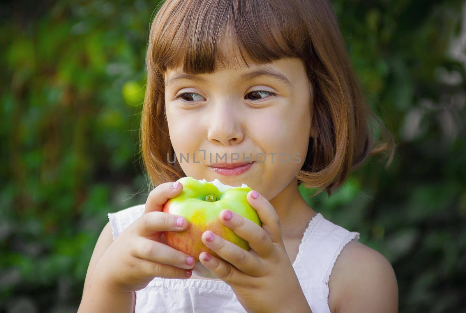 Child with an apple. Selective focus. nature by yanadjana