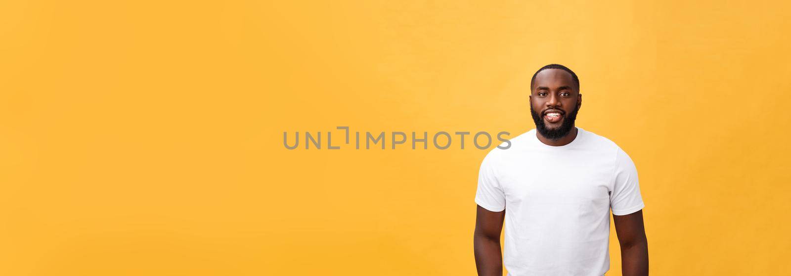 Portrait of a modern young black man smiling standing isolated yellow background.