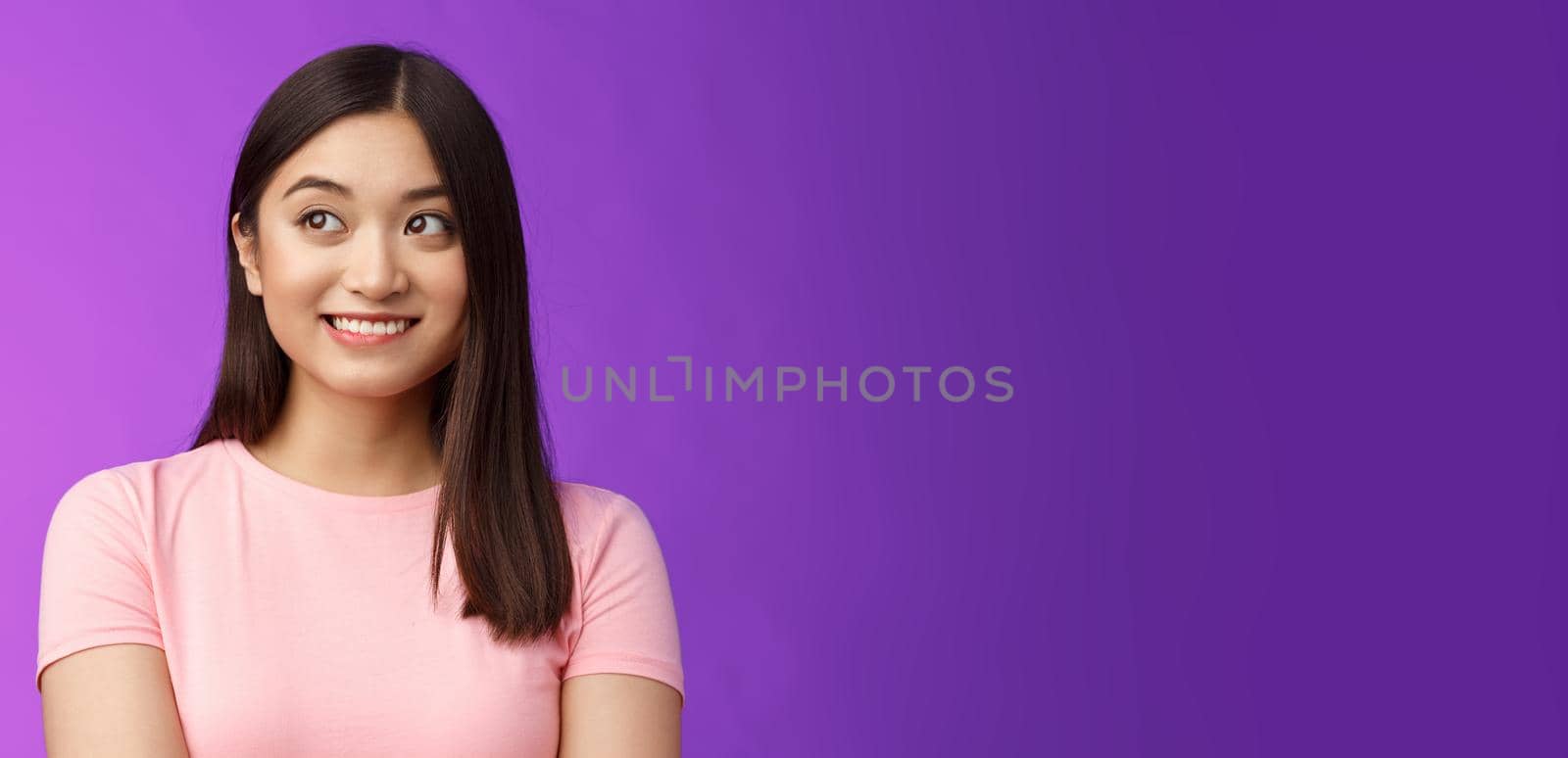 Close-up lovely joyful asian woman look away dreamy, smiling imaging cute thing, recall funny joke, thinking happy moment, stand modest purple background upbeat and silly by Benzoix