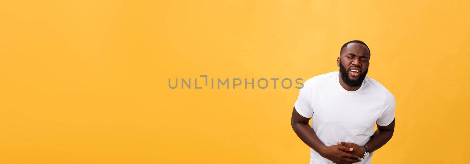 Young african american man wearing white t-shirt with hand on stomach because nausea, painful disease feeling unwell. Ache concept by Benzoix