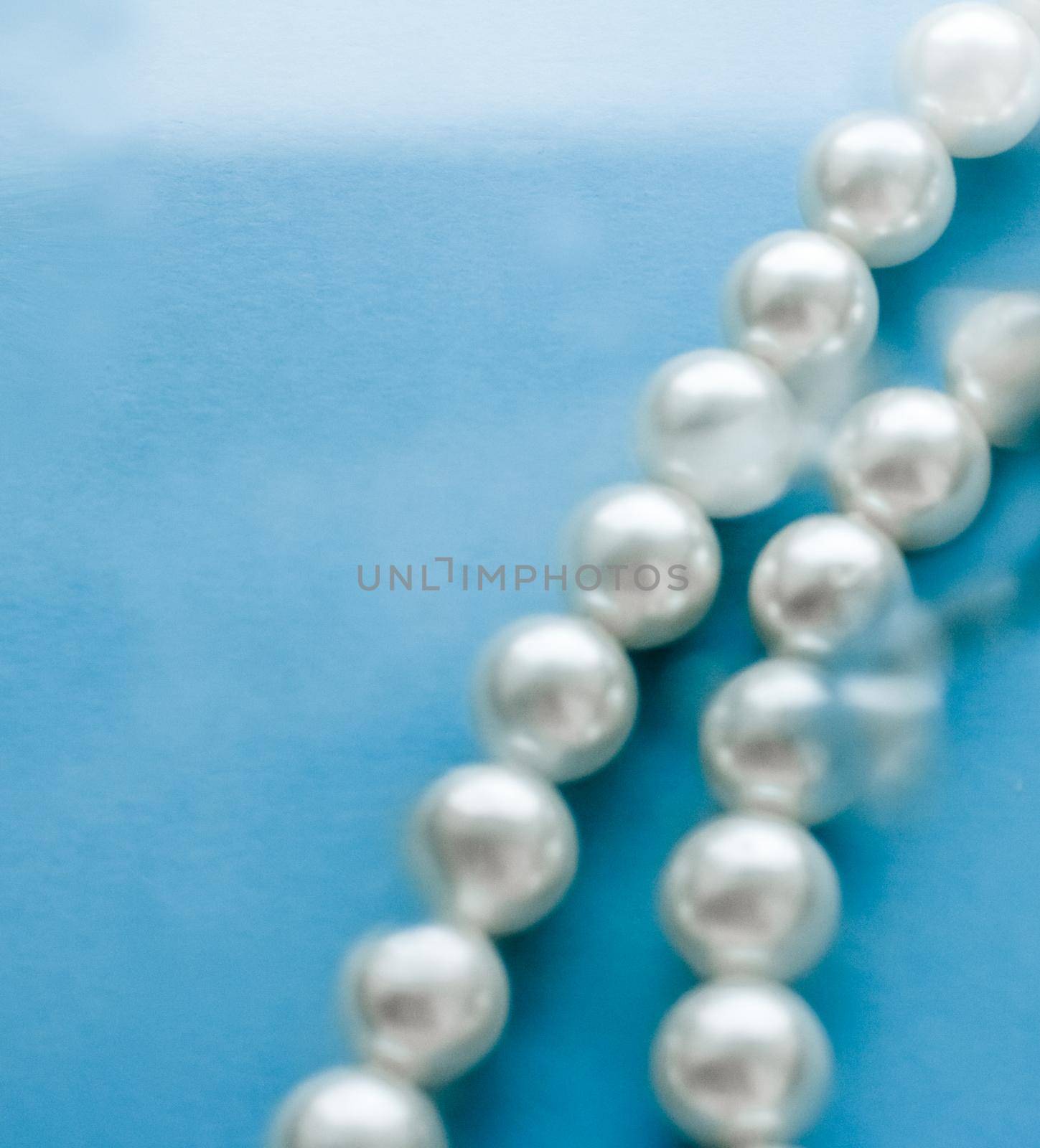 Jewelry, branding and gems concept - Coastal jewellery fashion, pearl necklace under blue water background, glamour style present and chic gift for luxury jewelery brand, holiday banner design