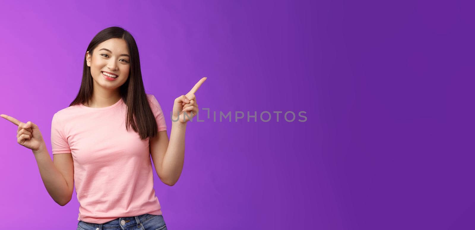 Charismatic relaxed cute asian woman short haircut pointing sideways introduce variety choices, showing left and right products, smiling joyfully, easily making decision, stand purple background by Benzoix