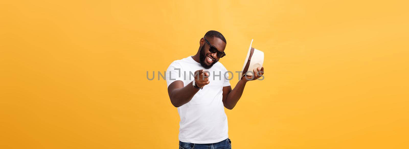 Young black man top dancing isolated on a yellow background