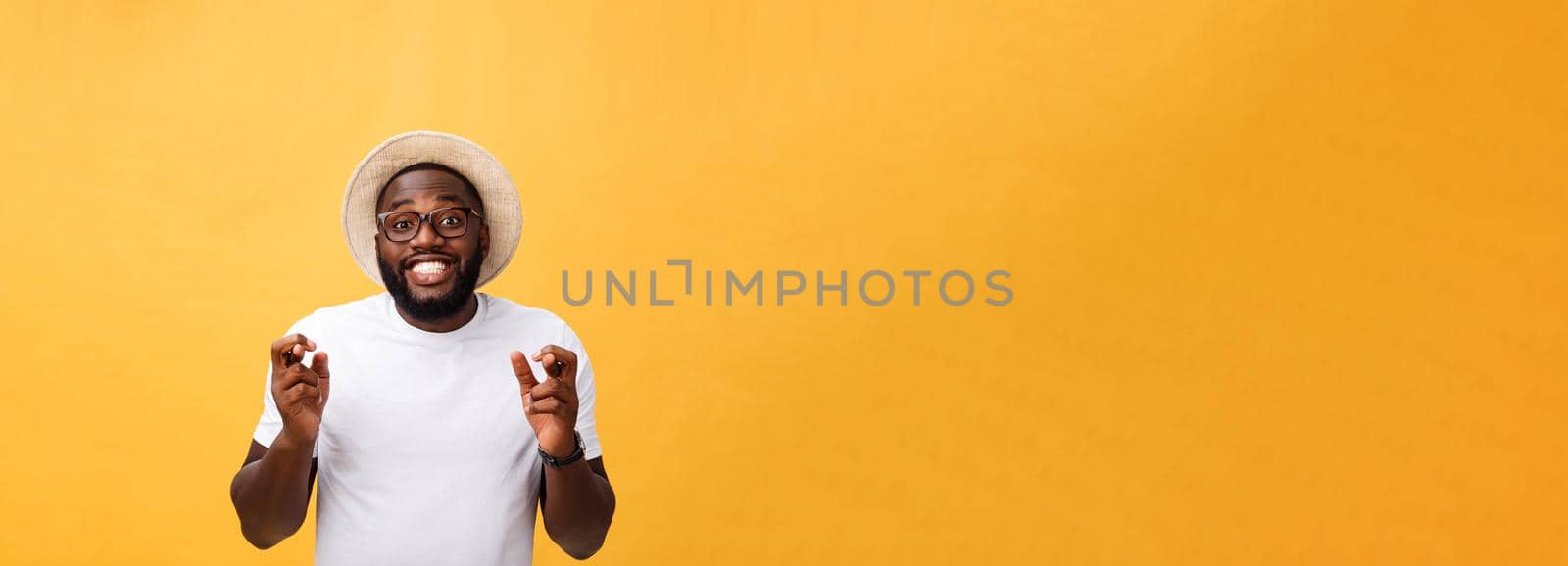 Young african american man over isolated background smiling crossing fingers with hope and eyes closed. Luck and superstitious concept by Benzoix