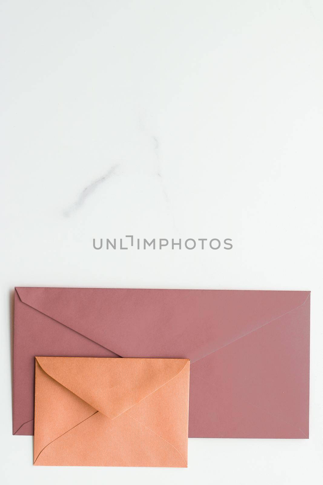 Postal service, newsletter and greeting card concept - Blank paper envelopes on marble flatlay background, holiday mail letter or post card message design