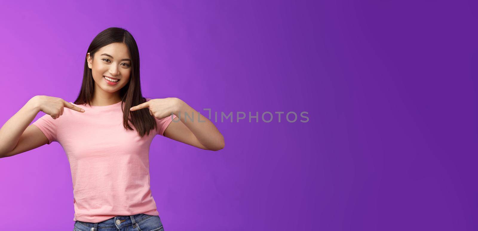 Active energized friendly tender asian stylish girl introduce herself, pointing chest proudly, smiling boastful, describe own achievements, bragging accomplishments, stand pleased purple background.
