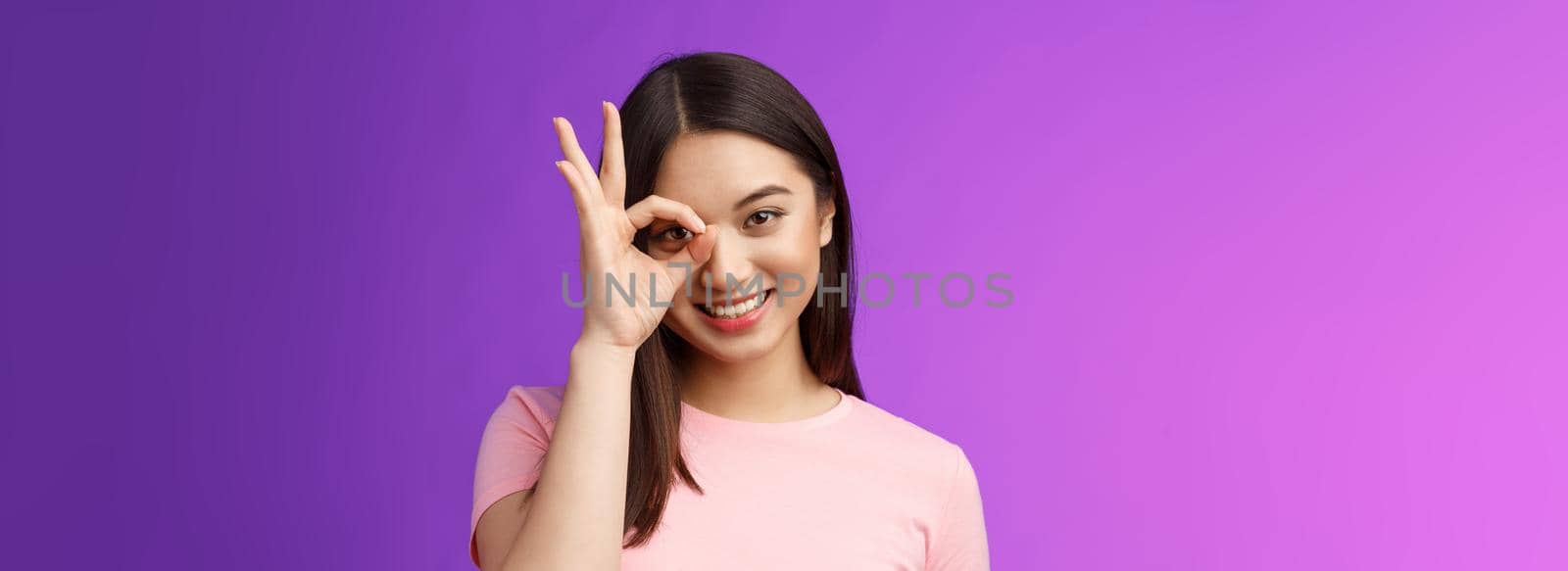 Close-up tender silly friendly asian woman stay positive, give permission show okay ok sign pleased, satisfied good quality, accept terms, delighted product, stand purple background. Copy space
