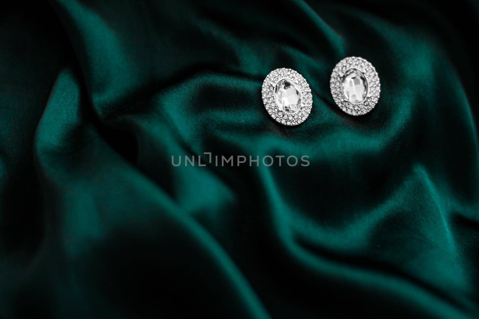 Jewellery brand, elegant fashion and bridal luxe gift concept - Luxury diamond earrings on dark emerald green silk, holiday glamour jewelery present