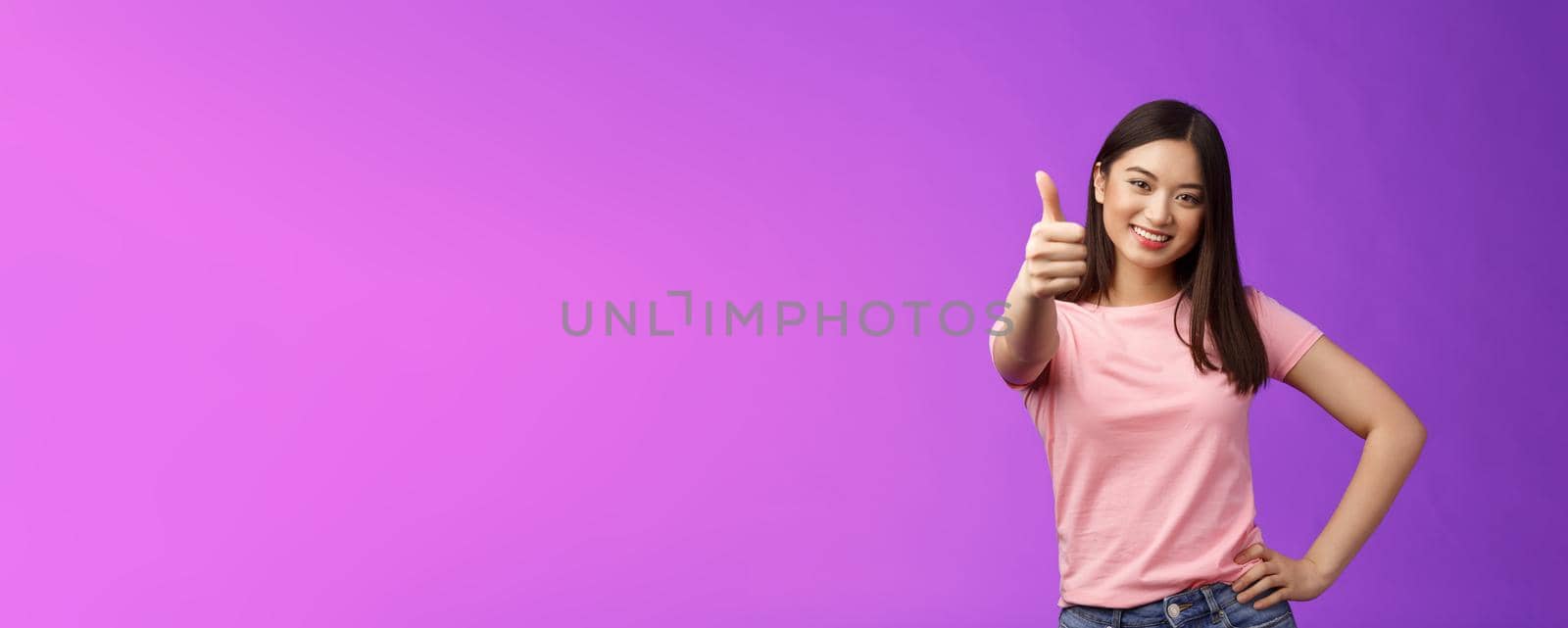 Good choice, well done. Pleased happy asian woman in pink t-shirt show thumb-up, approving like your idea, smiling joyfully, accept plan, agree, recommend product, give positive judgement.