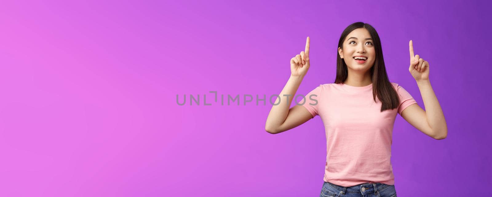 Impressed fascinated asian korean woman amazed, look pointing up admiration interest, check out cool promo, stand purple background, excited see awesome advertisement surprised.