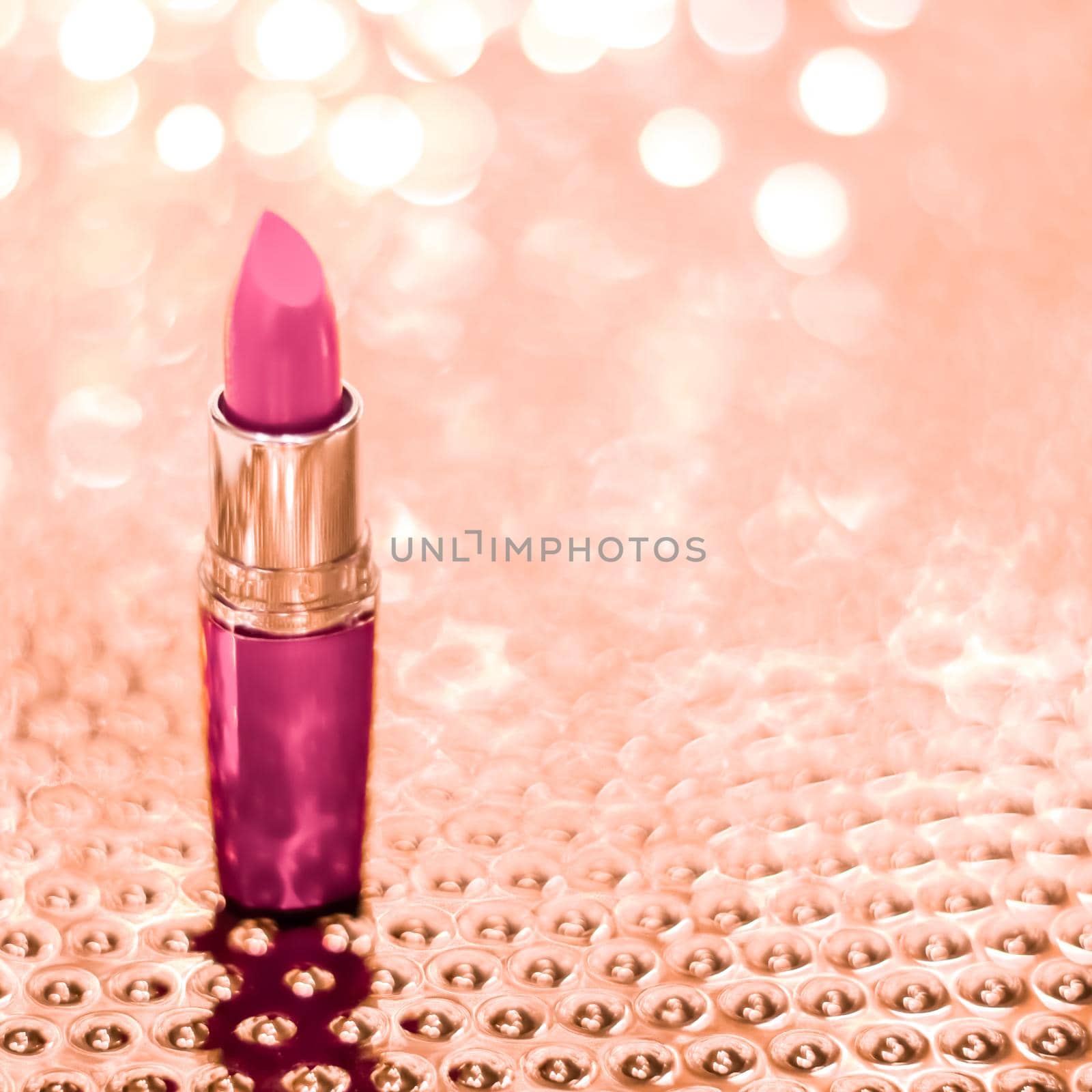 Cosmetic branding, sale and glamour concept - Pink lipstick on rose gold Christmas, New Years and Valentines Day holiday glitter background, make-up and cosmetics product for luxury beauty brand