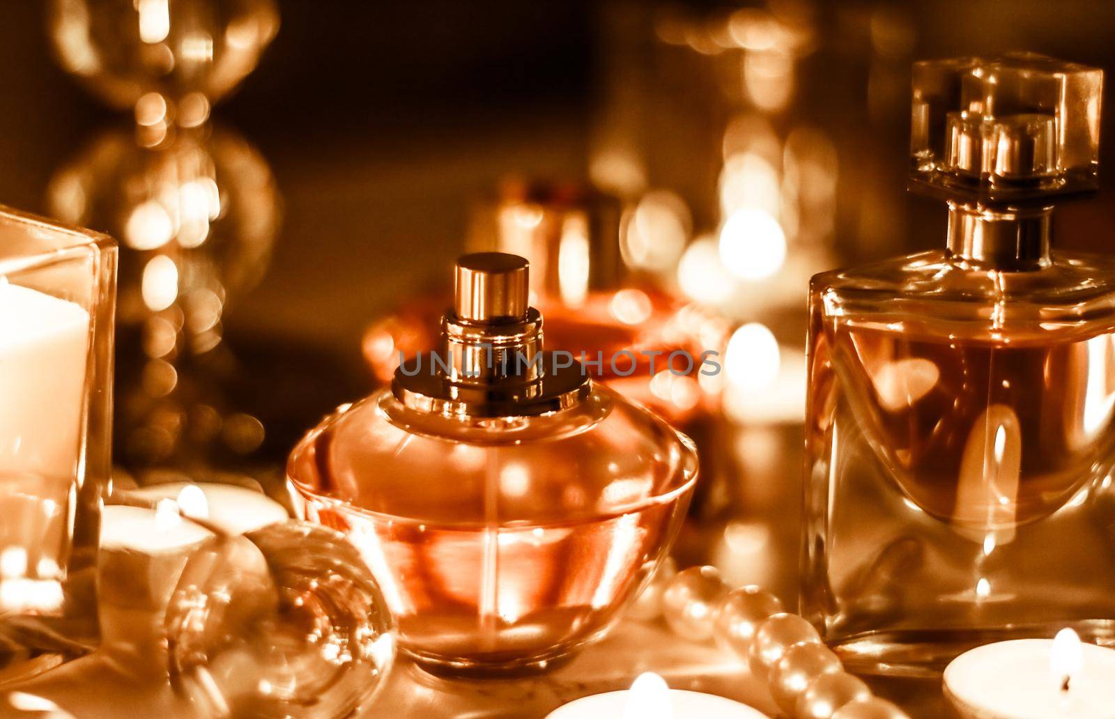 Perfumery, cosmetics branding and luxe concept - Perfume bottle and vintage fragrance on glamour vanity table at night, pearls jewellery and eau de parfum as holiday gift, luxury beauty brand present