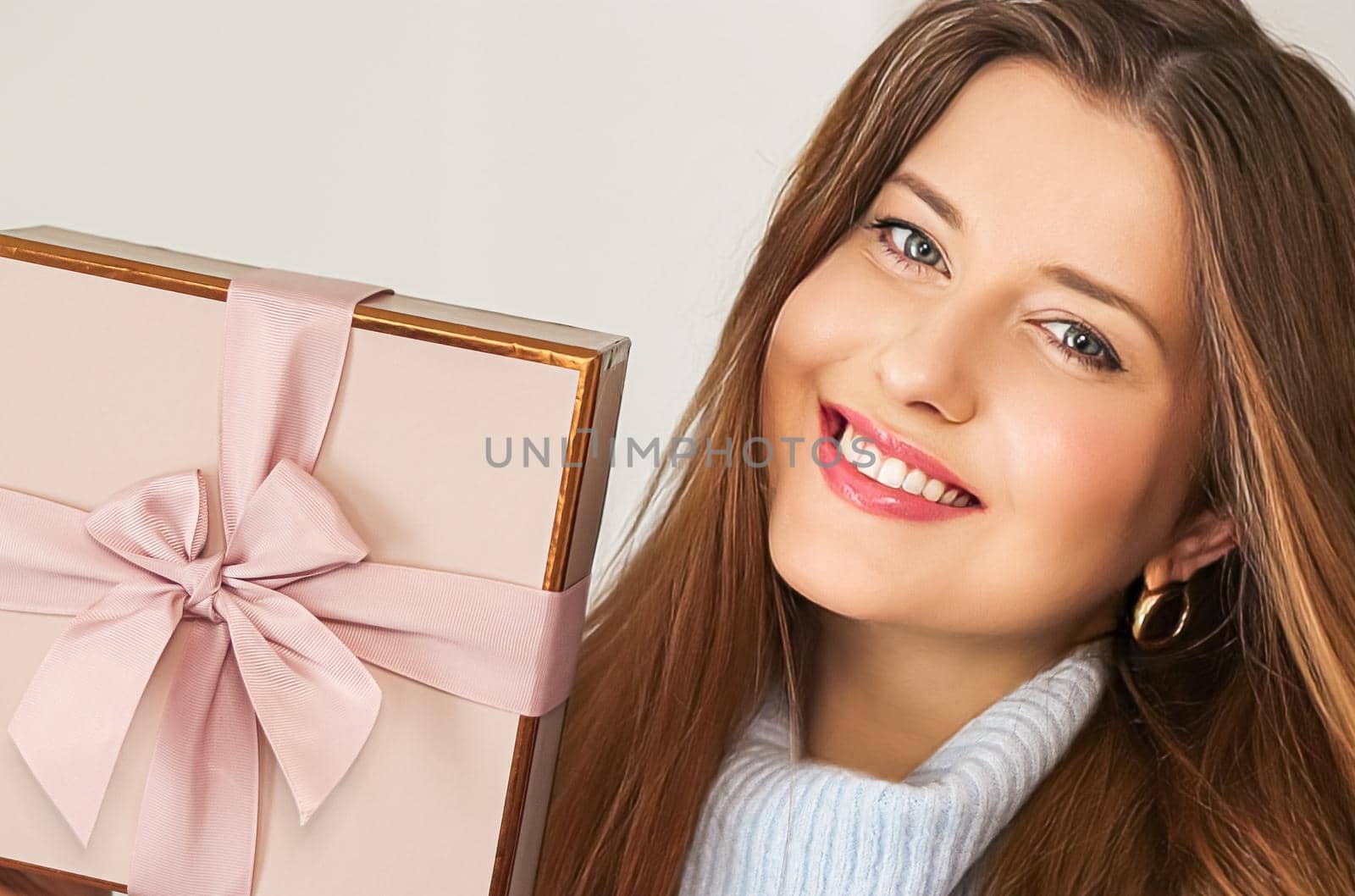 Winter holidays, present and Merry Christmas concept, happy woman smiling and holding wrapped gift box, close-up portrait