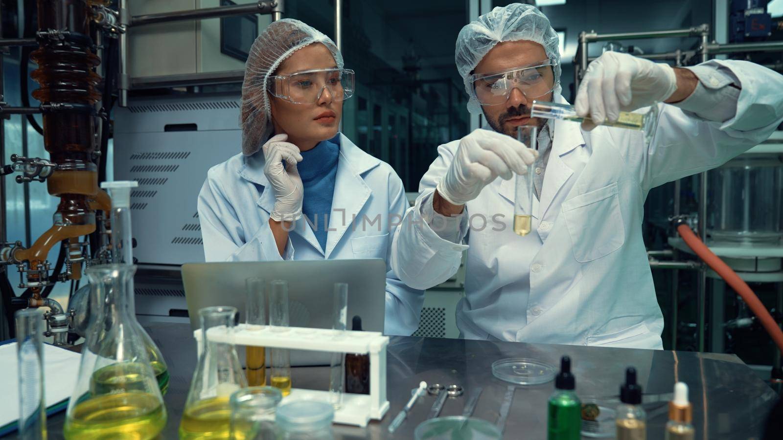 Two scientist in professional uniform working in laboratory for chemical and biomedical experiment