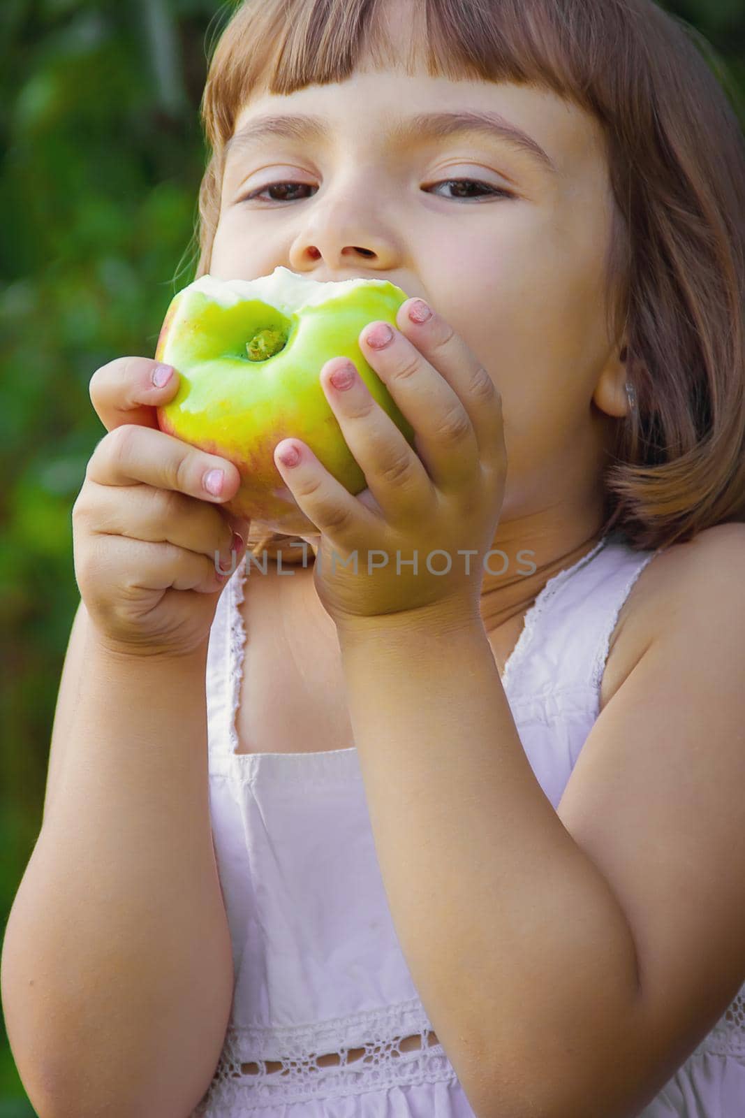 Child with an apple. Selective focus. nature by yanadjana