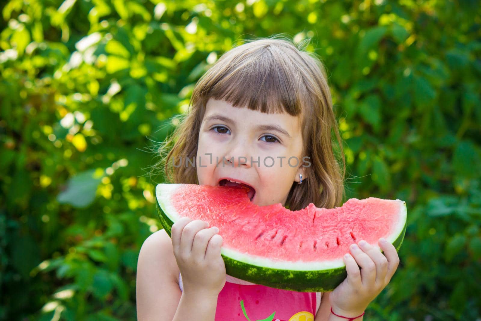 A child eats watermelon. Selective focus. Food. by yanadjana