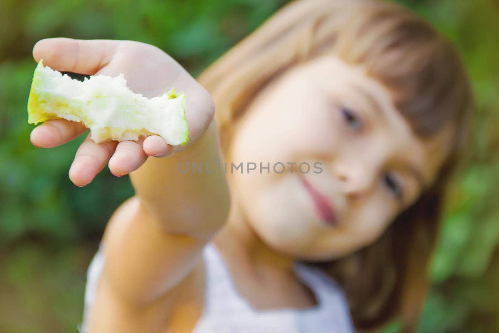 Child with an apple. Selective focus. nature food.