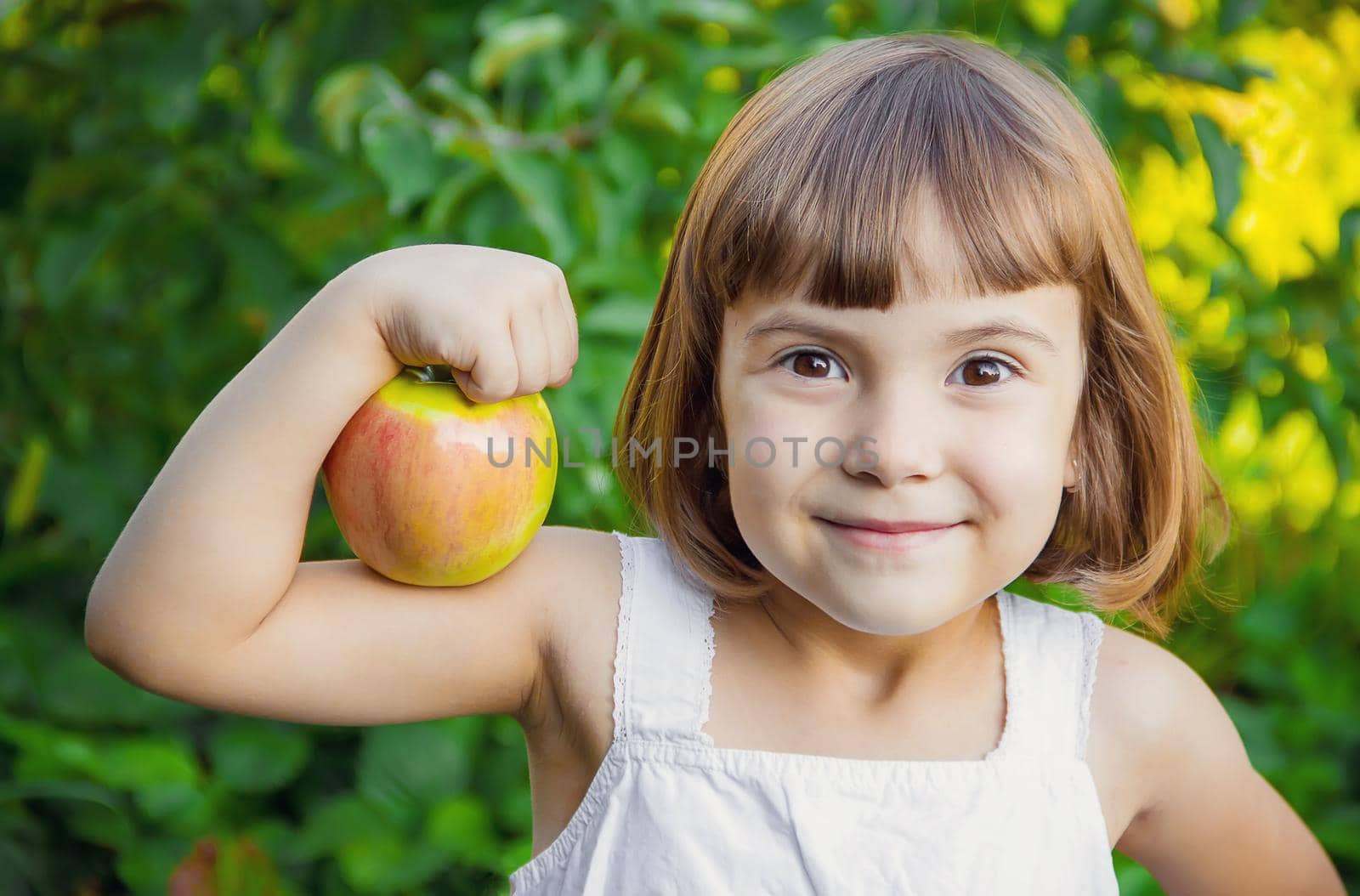 Child with an apple. Selective focus. nature by yanadjana