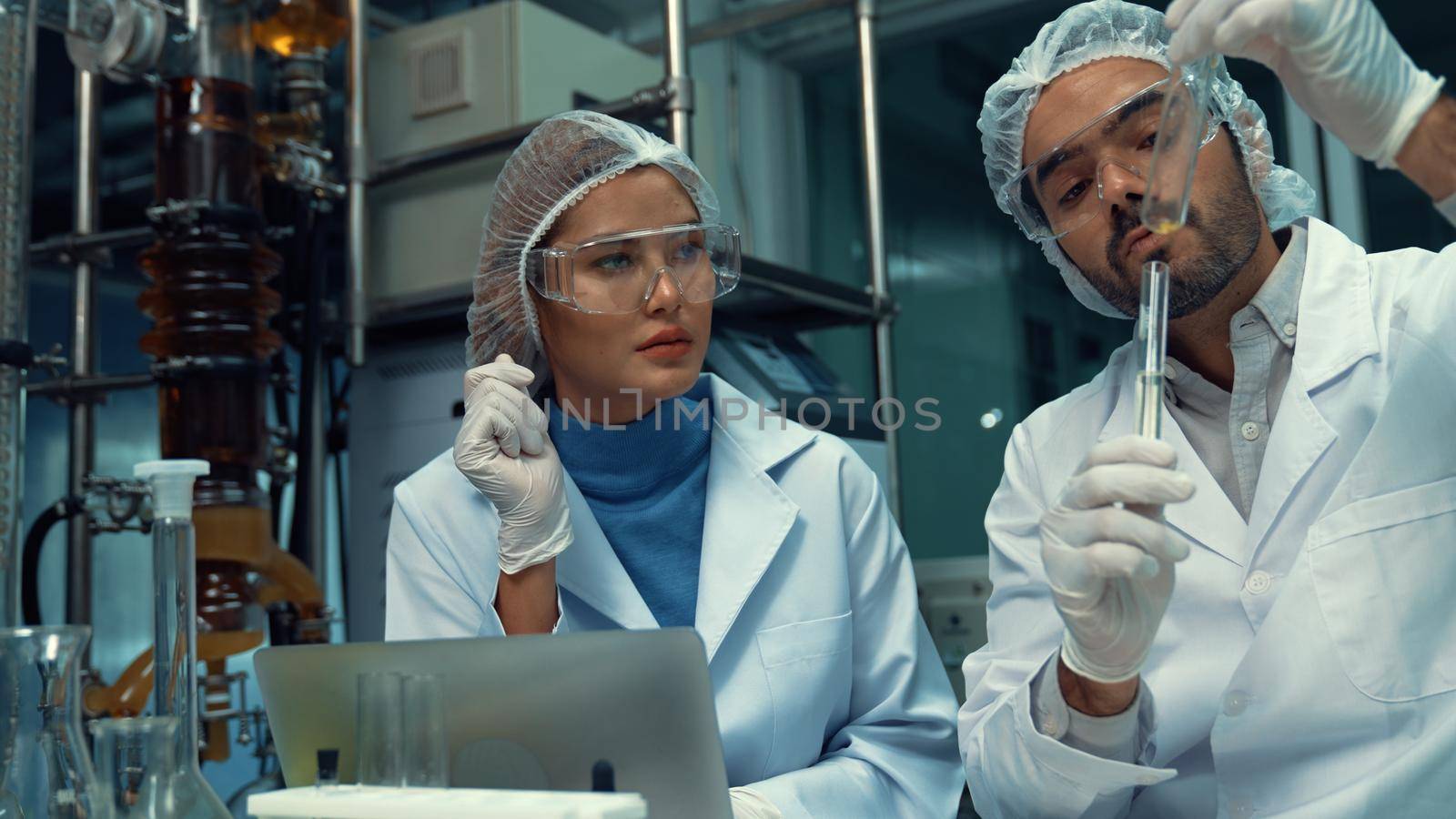 Two scientist in professional uniform working in laboratory for chemical and biomedical experiment