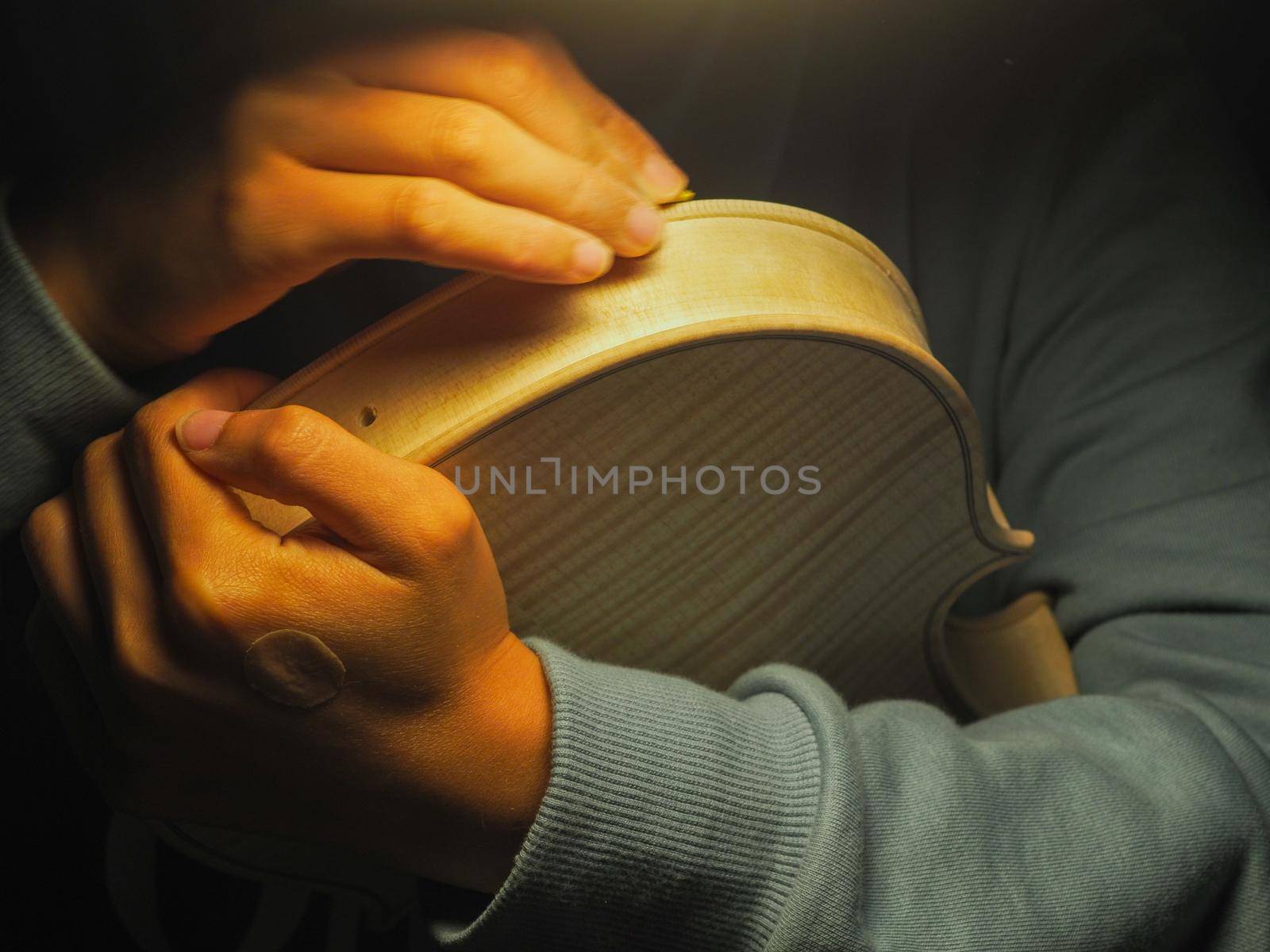 woman violinmaker at work with the fiddle
