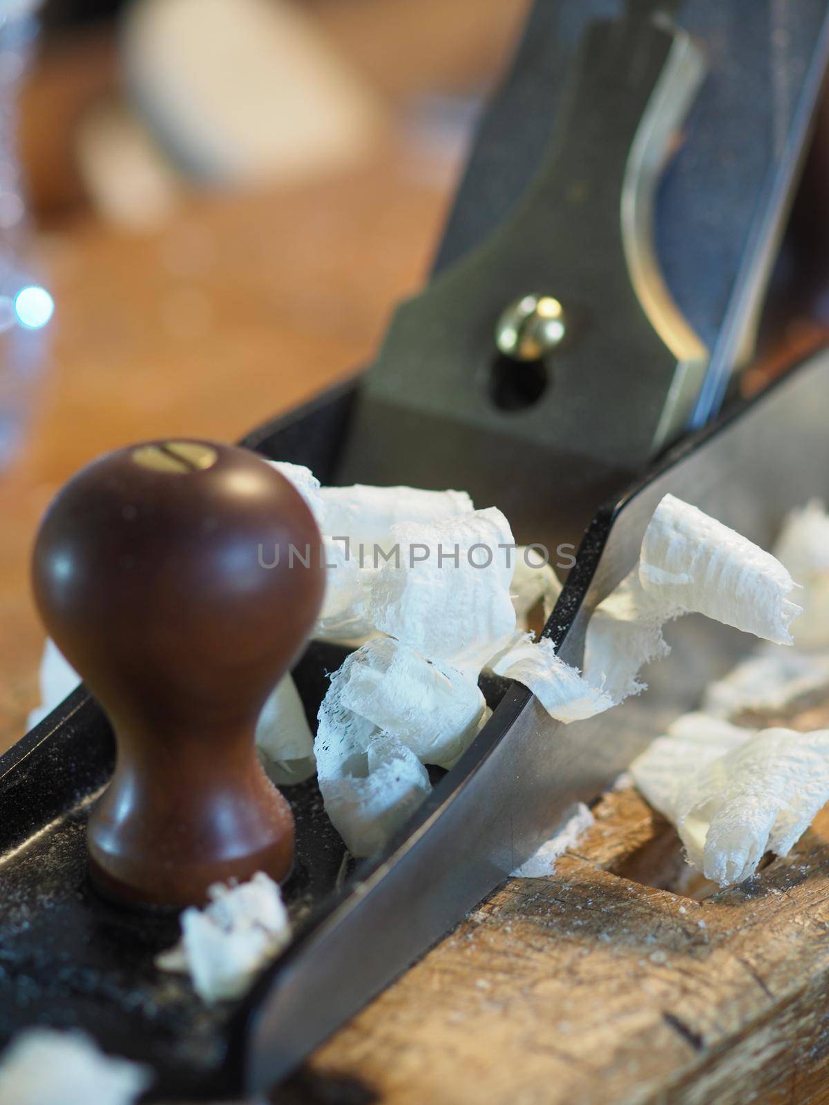 Close up of professional master artisan luthier painstaking detailed work on wood violin in a workshop.