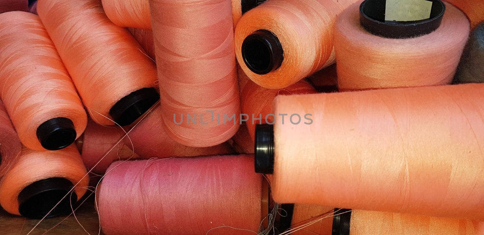 Colorful yarn on spool, yarn on tube, cotton, wool, linen thread orange by antoksena