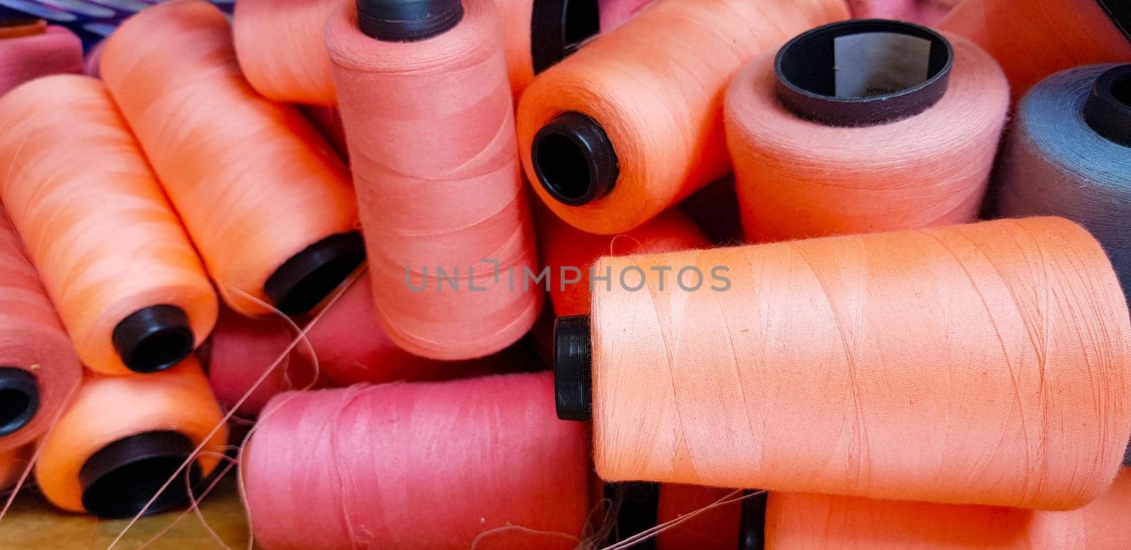 Colorful yarn on spool, yarn on tube, cotton, wool, linen thread orange