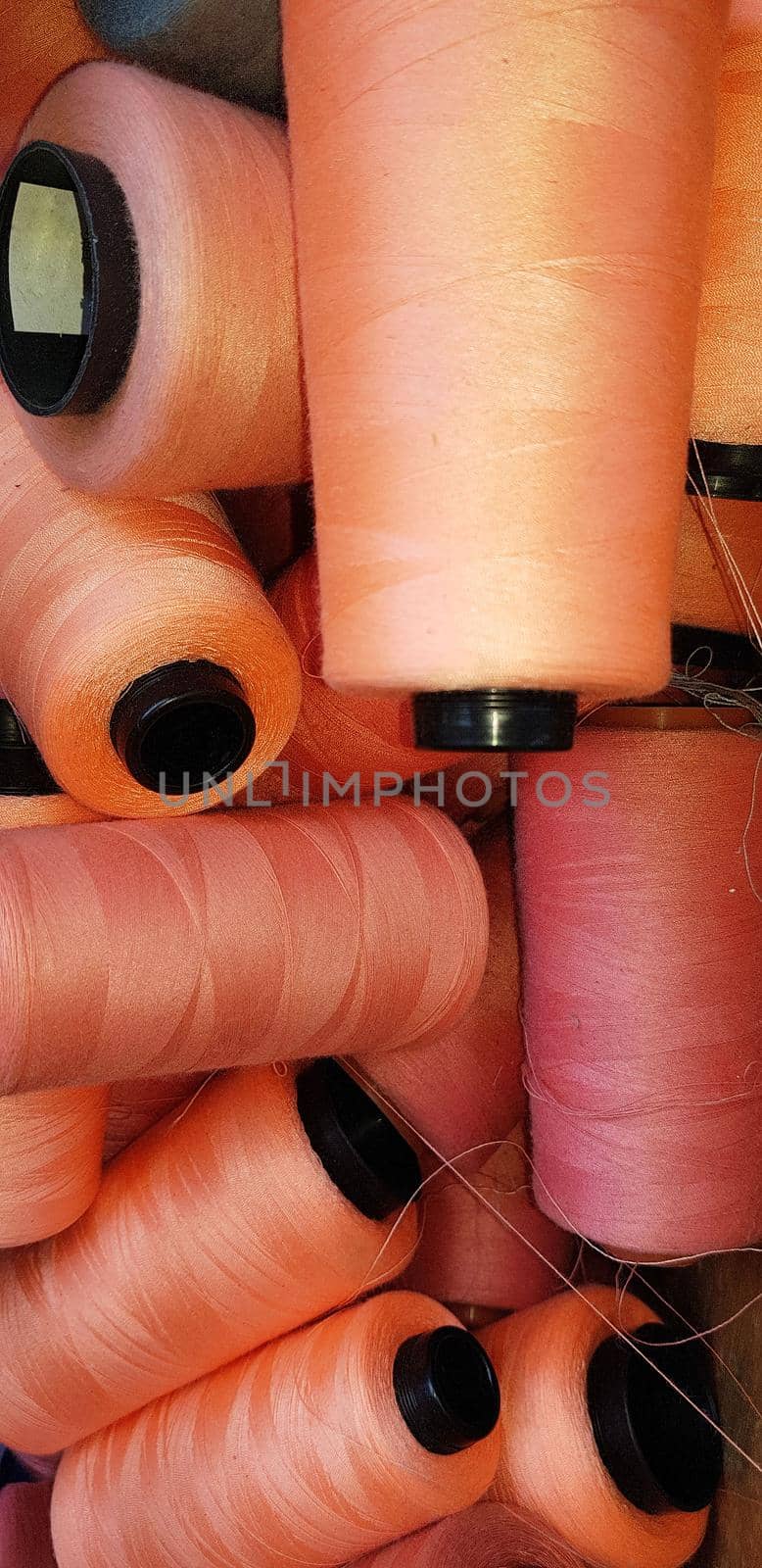 Colorful yarn on spool, yarn on tube, cotton, wool, linen thread orange