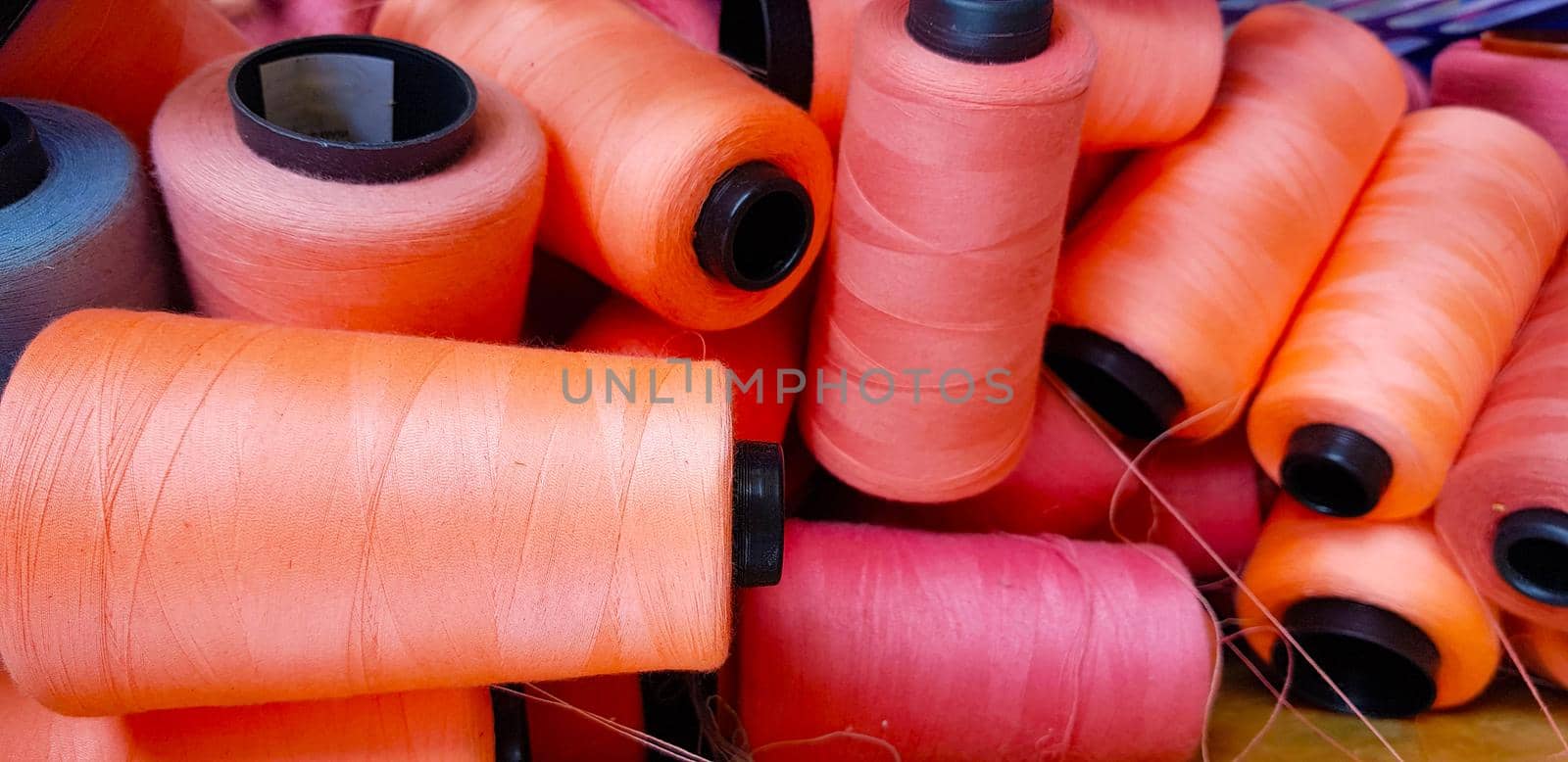 Colorful yarn on spool, yarn on tube, cotton, wool, linen thread orange by antoksena