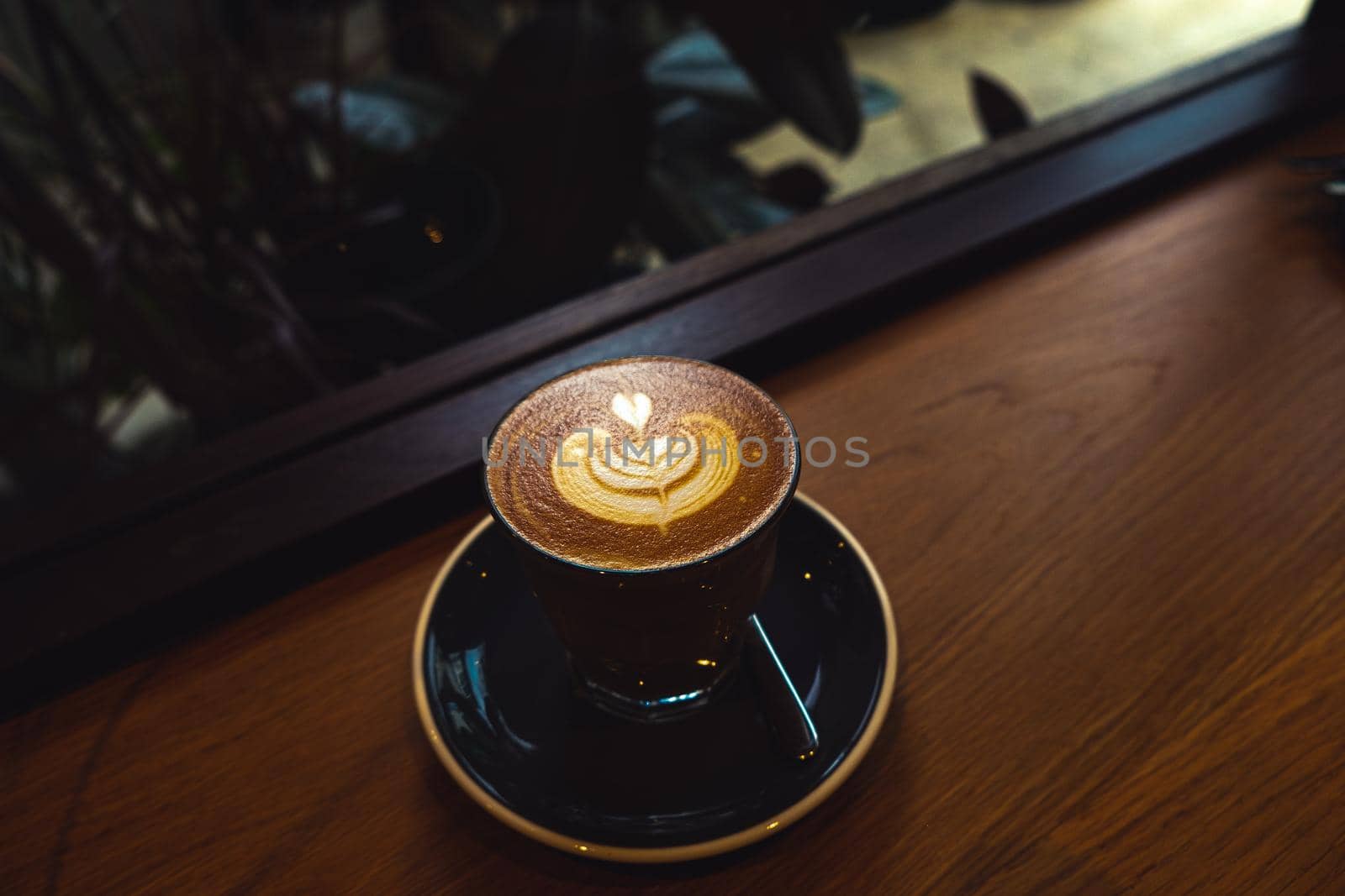 A cup of coffee latte top view with Microfoam milk leaf shape foam. by Petrichor