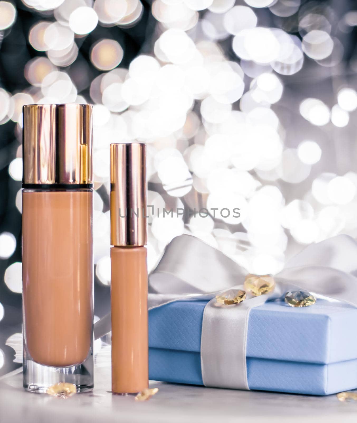 Cosmetic branding, Christmas glitter and girly blog concept - Holiday make-up foundation base, concealer and blue gift box, luxury cosmetics present and blank label products for beauty brand design