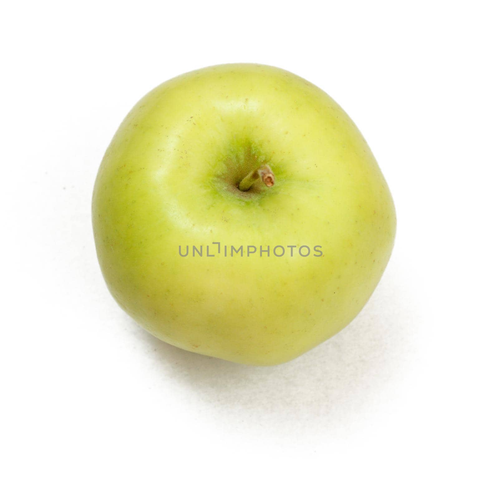 Ripe green apple on a white isolated background with shadow. Top view.
