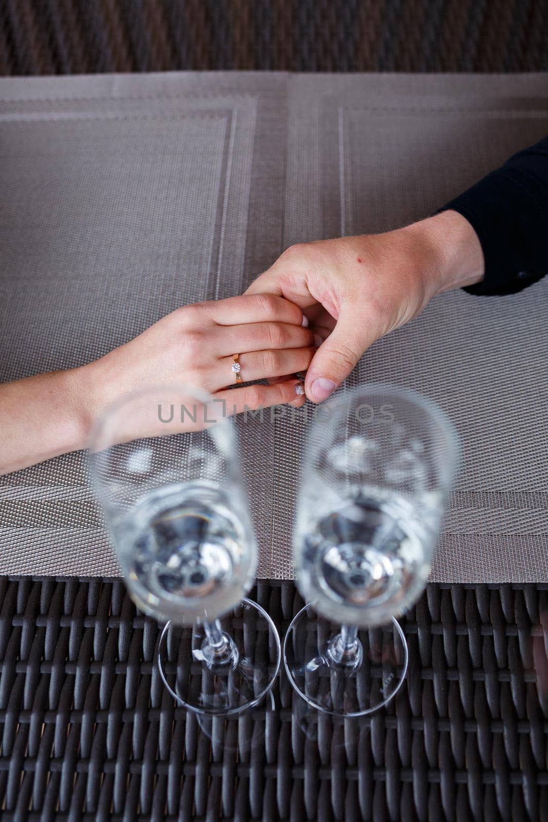 Served table in a restaurant for two. Blue plates for food, two glasses. Romantic evening concept