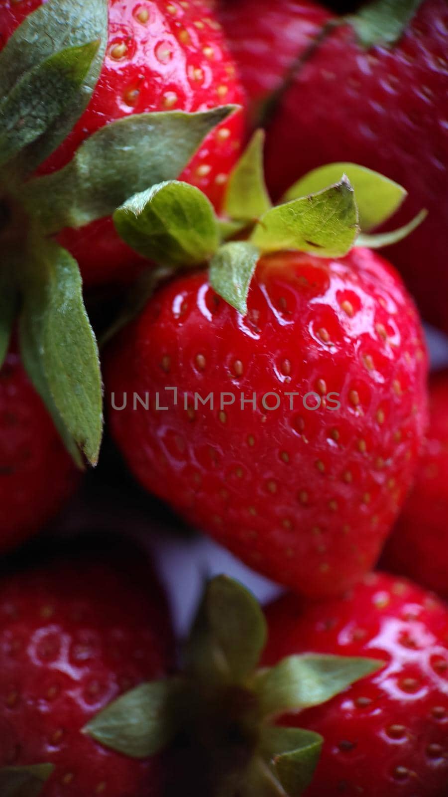Macrophotography.Harvest red strawberries on a white plate.Texture or background