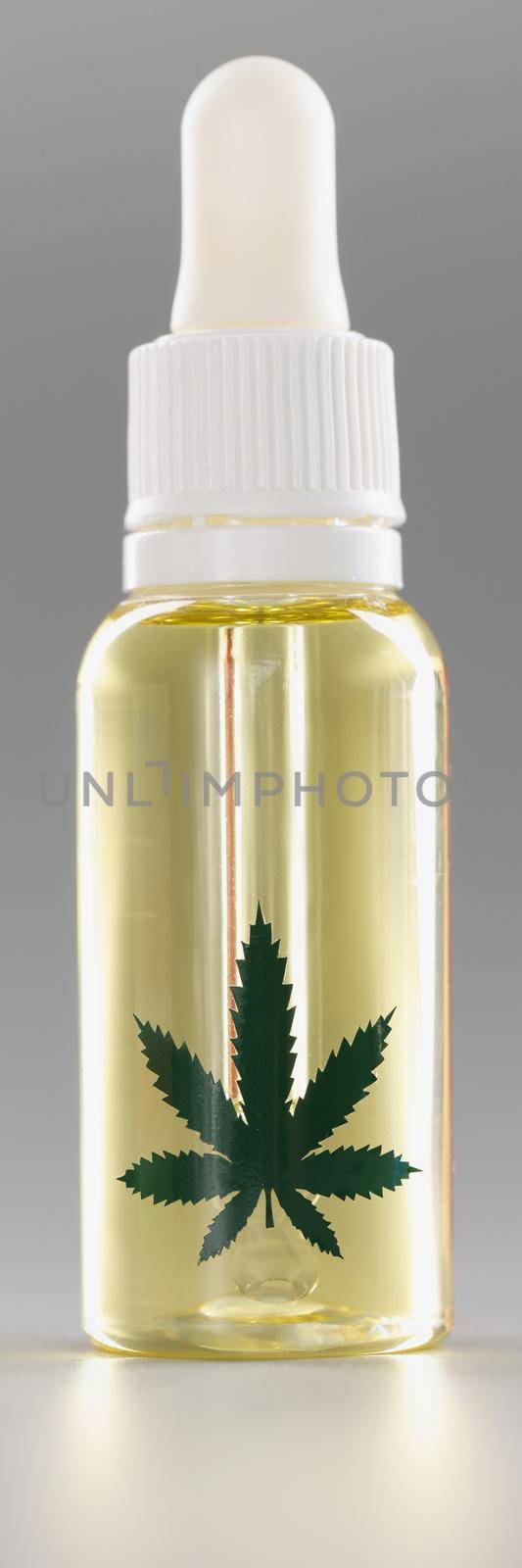 Bottle with liquid cannabis oil, healthy hemp plant for face or medication treatment by kuprevich