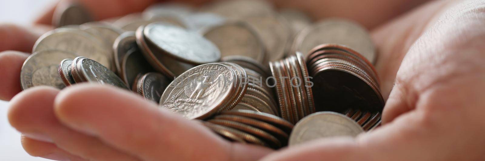 Close-up of pile of coins in businessman hands, earned money, work hard. Future needs, loan, credit spend on vacation, savings for future. Finance concept