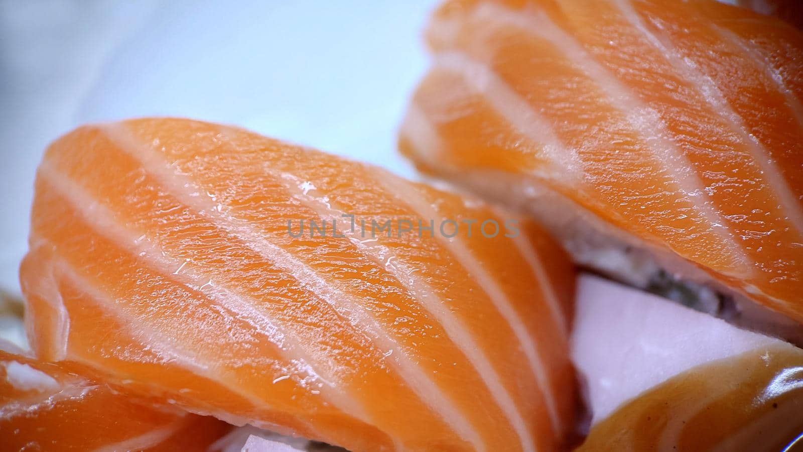 Traditional sushi rolls of Japanese cuisine from red fish.View from above.Texture or background.Macrophotography