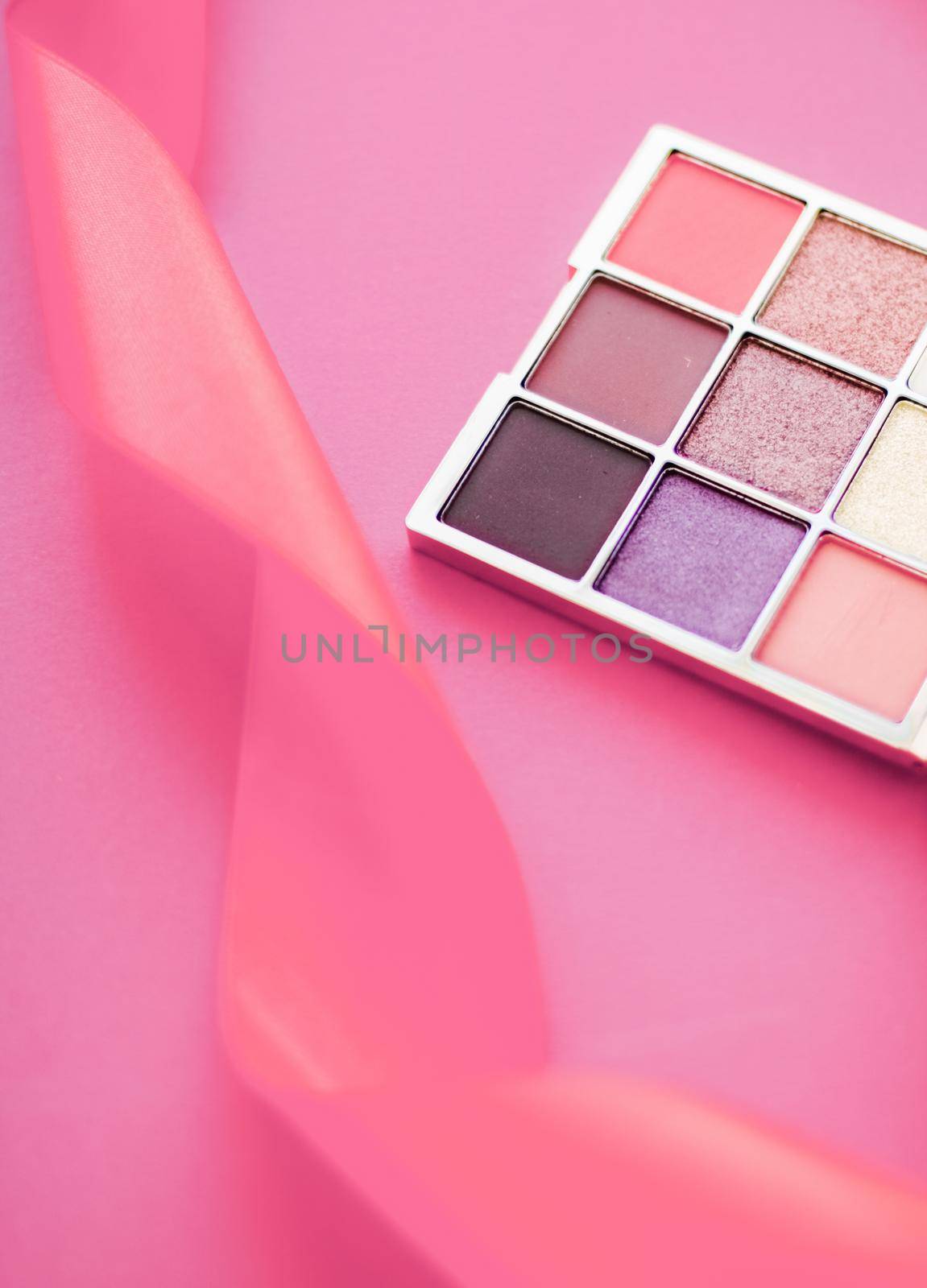 Cosmetic branding, mua and girly concept - Eyeshadow palette and make-up brush on rose background, eye shadows cosmetics product for luxury beauty brand promotion and holiday fashion blog design