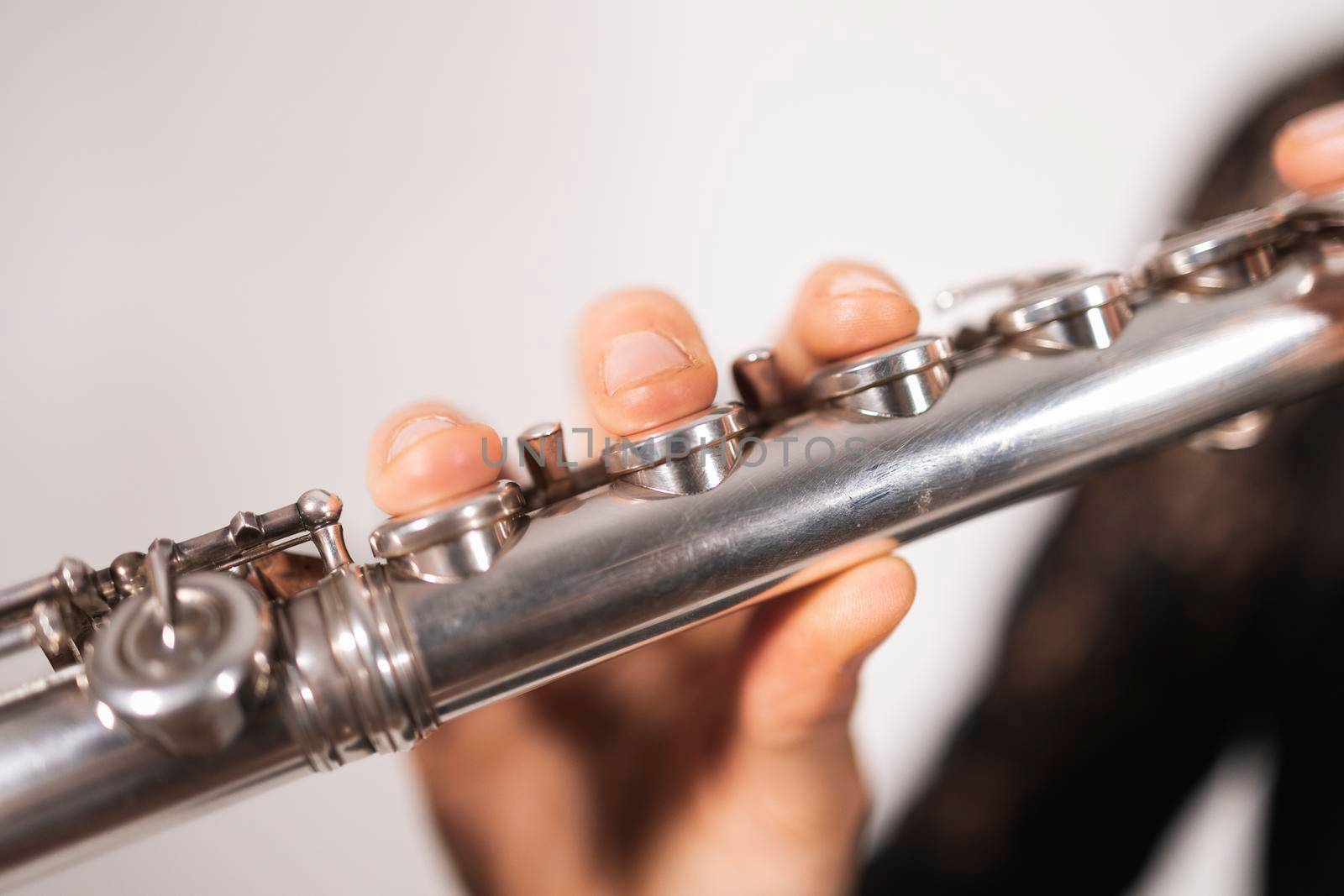 Close up of the hand of a female flutist showing the correct technique while playing