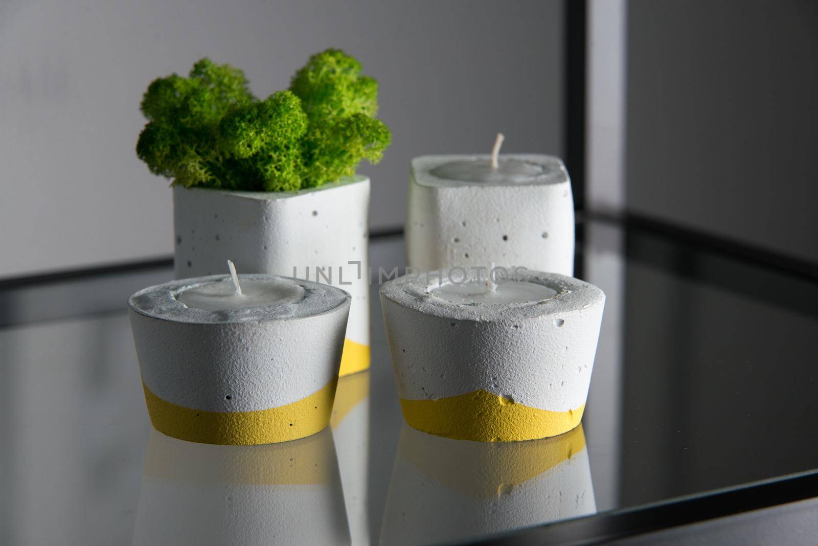 candles and moss in white and yellow concrete candle holders by Ashtray25