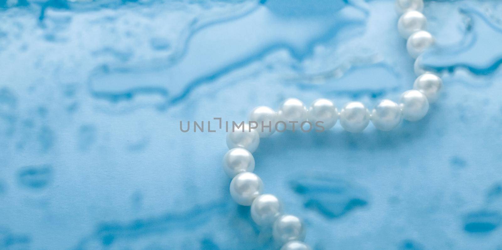 Jewelry, branding and gems concept - Coastal jewellery fashion, pearl necklace under blue water background, glamour style present and chic gift for luxury jewelery brand, holiday banner design