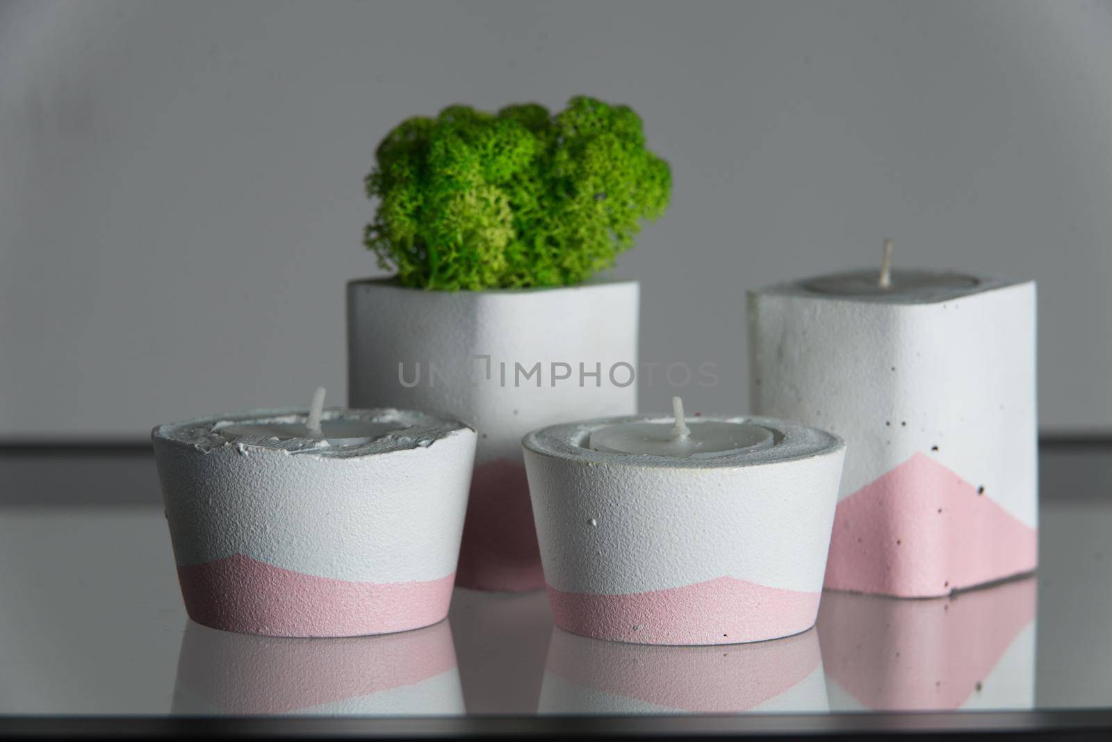 candles and moss in white and pink concrete candle holders by Ashtray25