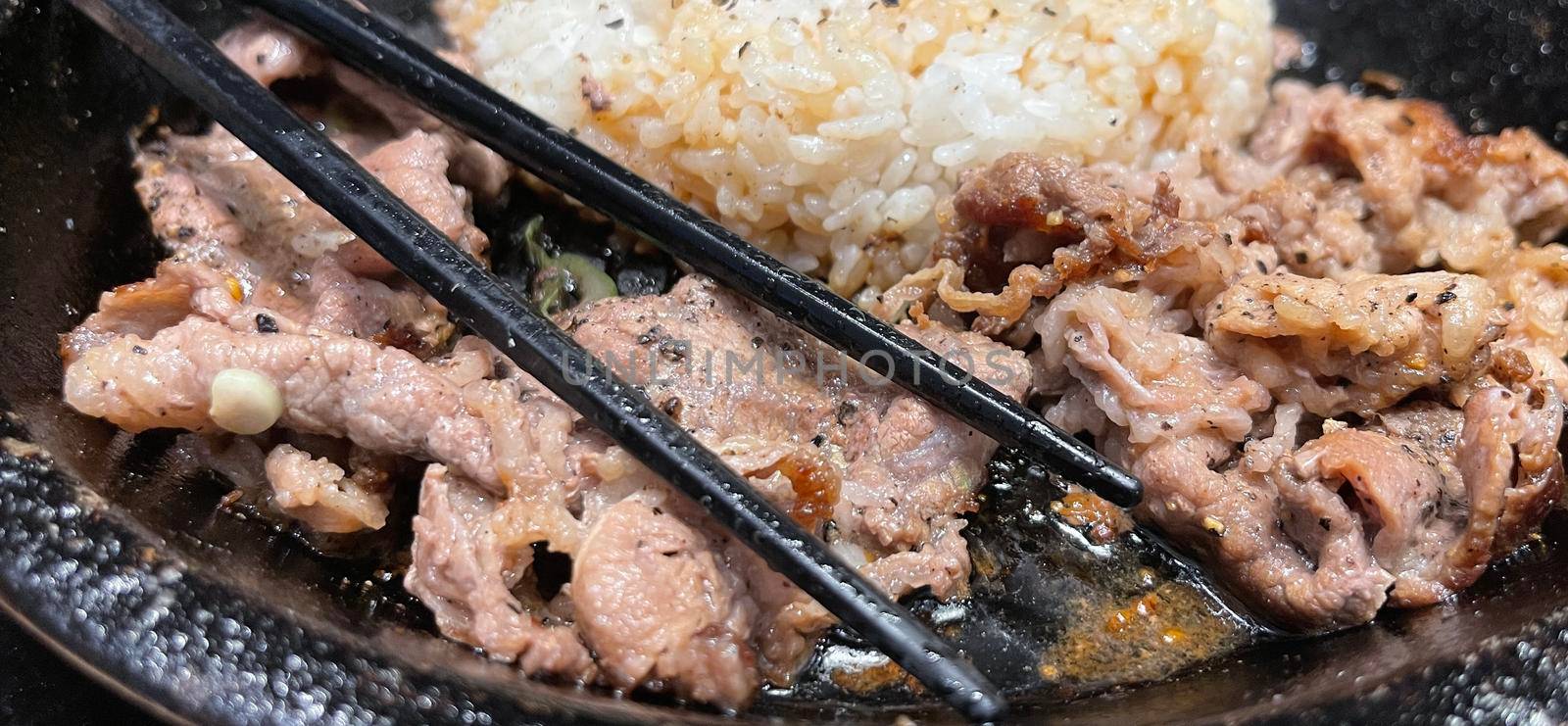 selective focus grilled beef steak with korean sauce bulgogi on top of rice with slice of pepper and sweet corn - korean and japanese food style by antoksena