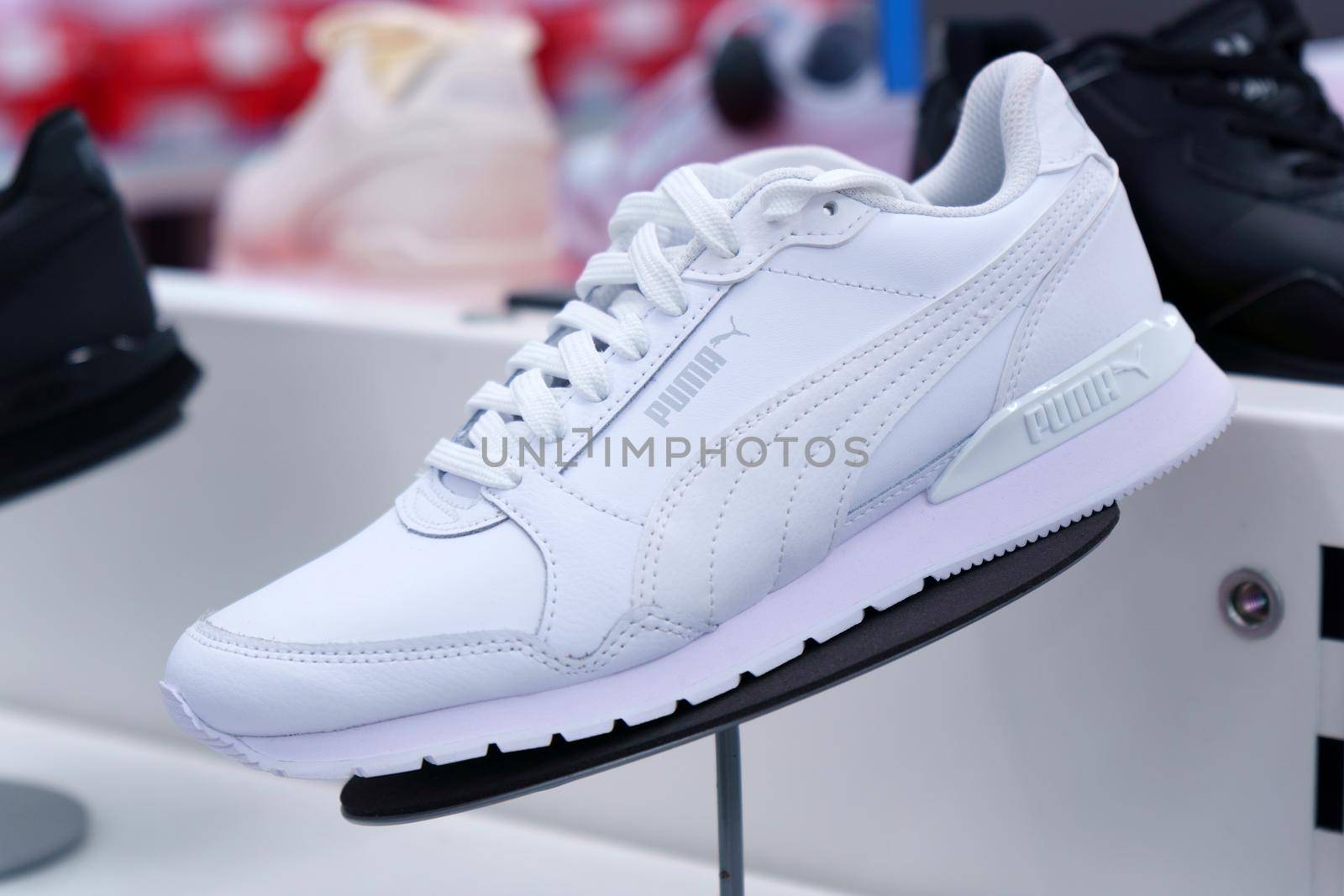Tyumen, Russia-August 12, 2022: New Puma shoes, white sneakers, trainers showing the logo. Sport and casual footwear concept. Selective focus by darksoul72