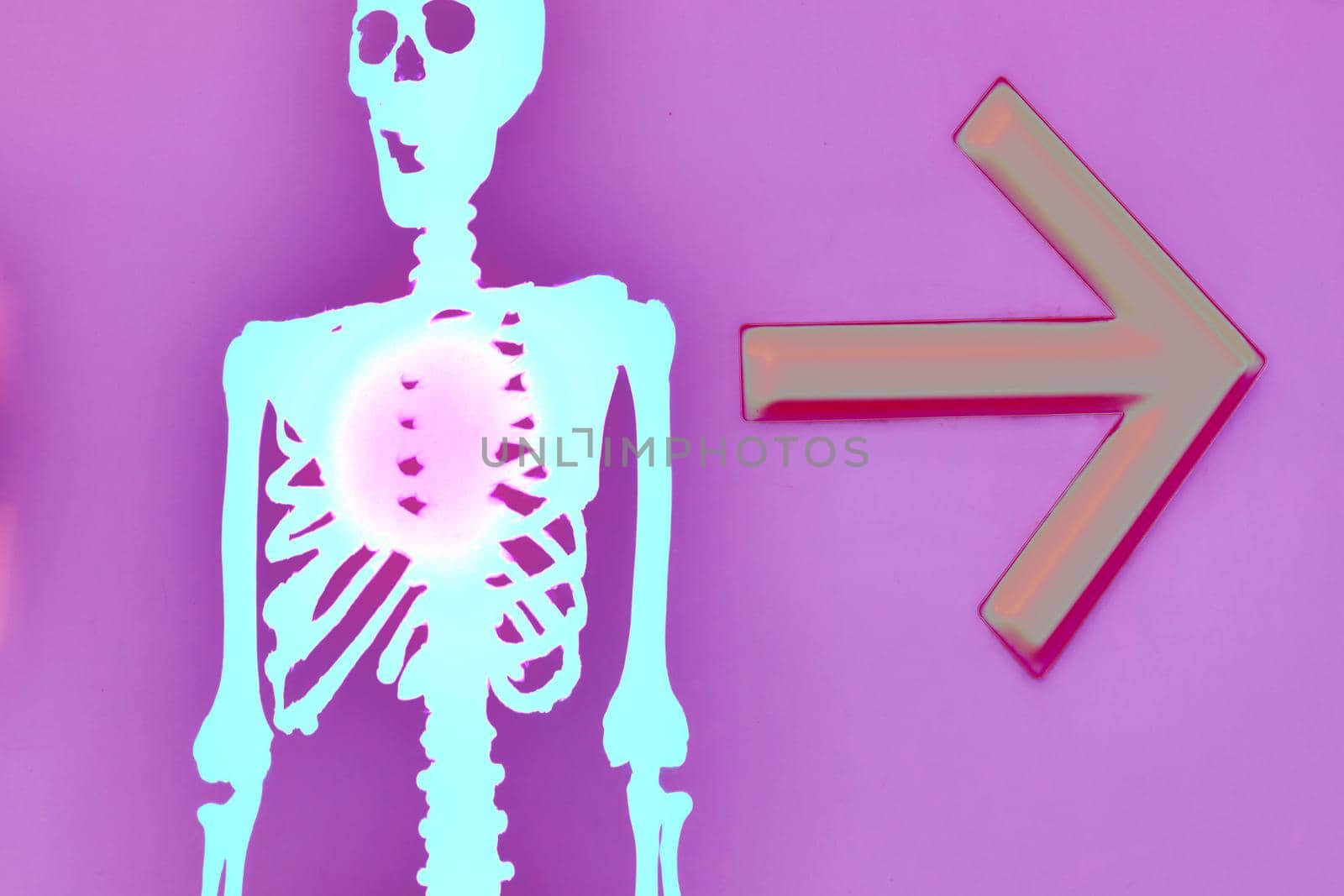 the night of October 31, the eve of All Saints' Day, commonly celebrated by children who dress in costume . Halloween blue funny skeleton with an arrow the direction on a pink