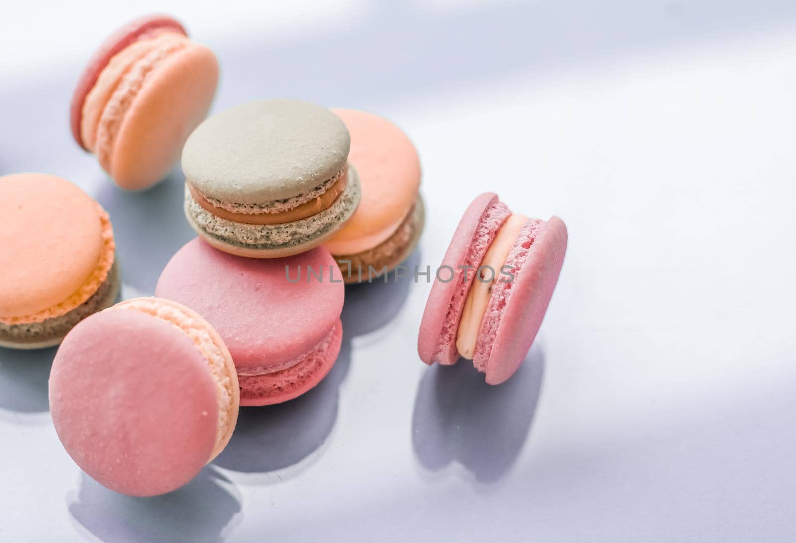 Pastry, bakery and branding concept - French macaroons on blue background, parisian chic cafe dessert, sweet food and cake macaron for luxury confectionery brand, holiday backdrop design