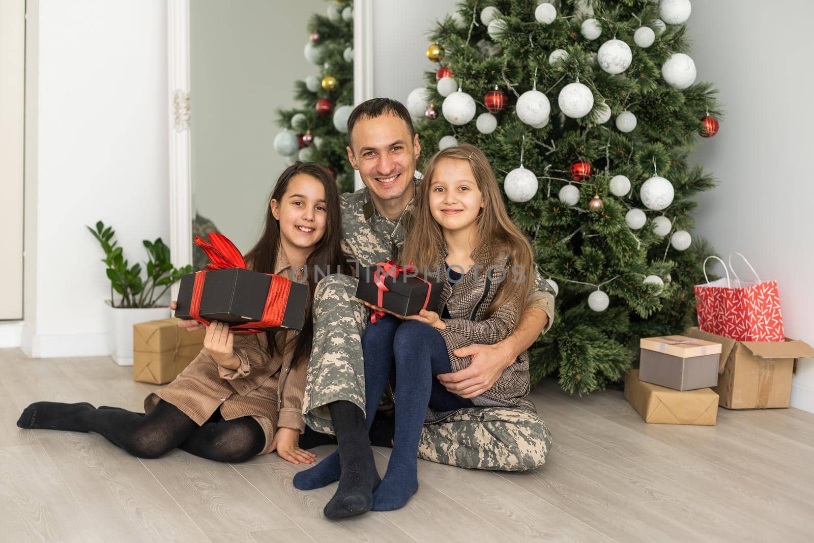 military father and children near christmas tree.