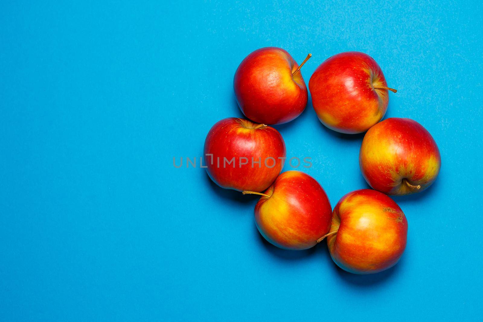 red-yellow juicy apples on a blue background. Healthy Nutrition and Vitamins